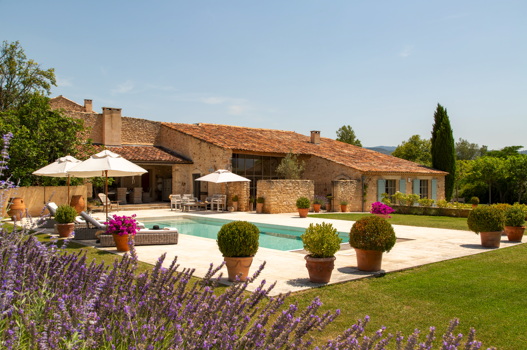 beautiful Provence villa with swimming pool, Mediterranean architecture, stone walls, terracotta tiles, cypress trees, lavender garden, golden hour lighting, luxury outdoor living, photographic style